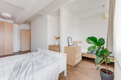 a bedroom with a bed and a potted plant at Central Cool Apt with terrace - Leg11 in Prague