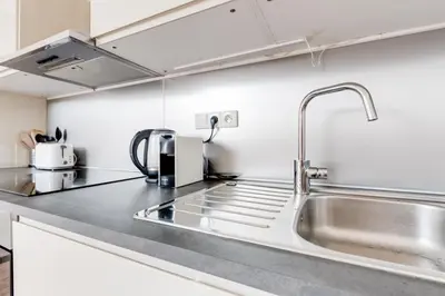 a kitchen with a stainless steel sink and a counter top at Central Cool Apt with terrace - Leg11 in Prague