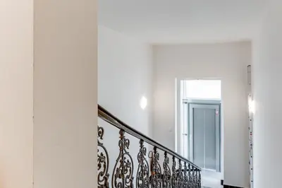 a staircase in a house with white walls at Central Cool Apt with terrace - Leg11 in Prague