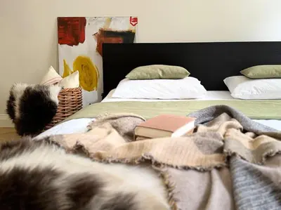 a cat with a witch hat laying on a bed at Chic Prague Apartment in Prague