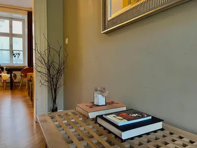 a bathroom with a shelf with towels and a mirror at Chic Prague Apartment in Prague