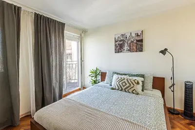 a bedroom with a bed and a window at Modern Attic with Terrace - machova in Prague