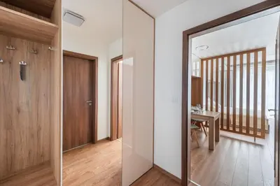 a hallway with a glass door and a table at Luxury & air-conditioned Osko Apartment near the city center in Prague