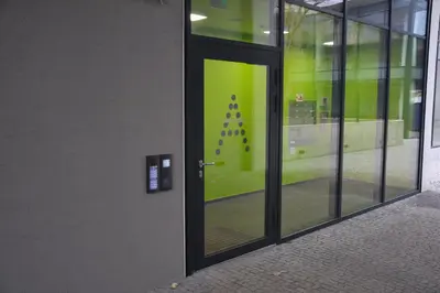 a door with a green sign on the side of a building at Luxury & air-conditioned Osko Apartment near the city center in Prague
