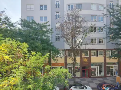 a tall white building with trees in front of it at Luxury & air-conditioned Osko Apartment near the city center in Prague