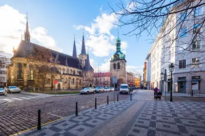 a cobblestone street in a city with a church at Bellagio Apartment in Prague
