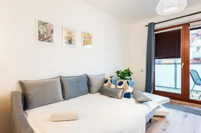 a living room with a couch and a window at Diamond River in Prague