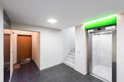 a hallway with a door and stairs in a building at Diamond River in Prague