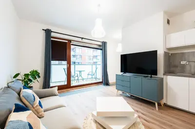 a living room with a couch and a tv at Diamond River in Prague