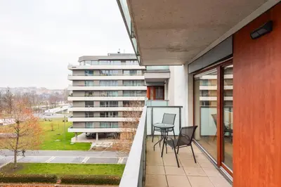 a balcony of a building with two chairs and a table at Diamond River in Prague