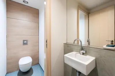 a bathroom with a white toilet and a sink at Diamond River in Prague