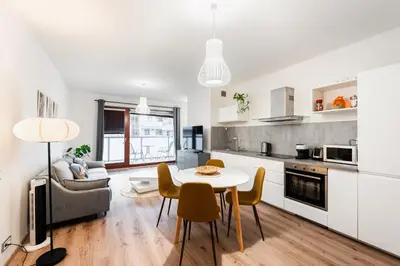 a kitchen and living room with a table and chairs at Diamond River in Prague