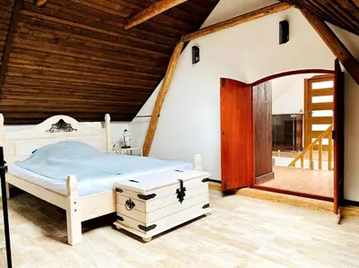 a bedroom with a bed and a wooden ceiling at Historická chalupa Lhotky 1844 - soukromí a klid u Sázavy in Malotice