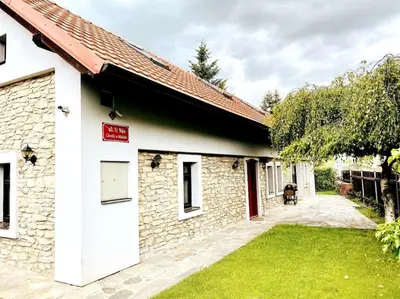 a stone building with a red sign on it at Historická chalupa Lhotky 1844 - soukromí a klid u Sázavy in Malotice