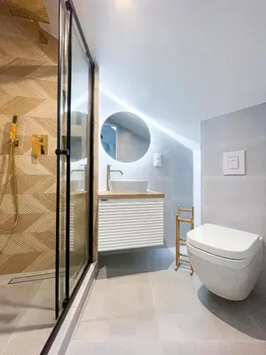 a bathroom with a toilet and a sink at Rentero Artsy Roof Top Apartment in City Centre in Prague