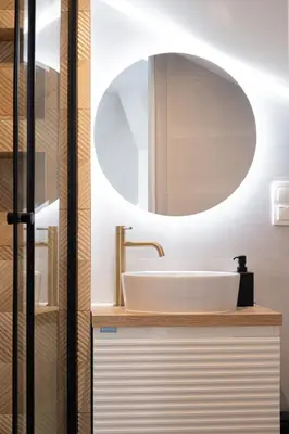 a bathroom with a sink and a mirror at Rentero Artsy Roof Top Apartment in City Centre in Prague