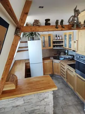 a kitchen with a white refrigerator and wooden cabinets at Very comfortable flat for the whole family in Prague