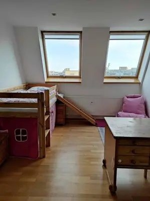 a room with two beds and a table and two windows at Very comfortable flat for the whole family in Prague