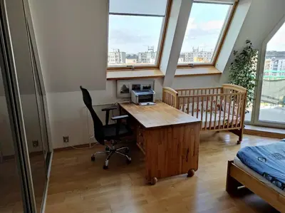 a bedroom with a desk with a bed and a crib at Very comfortable flat for the whole family in Prague