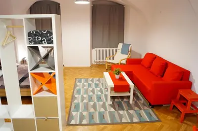 a living room with a red couch and a table at U Koniáše in Litoměřice