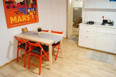 a kitchen with a table and four chairs in a room at U Koniáše in Litoměřice
