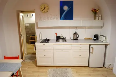 a kitchen with white cabinets and a sink at U Koniáše in Litoměřice