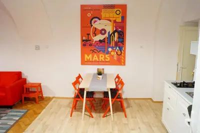 a table and chairs in a kitchen with a painting on the wall at U Koniáše in Litoměřice