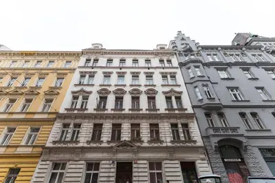 a tall white building with many windows at Dream Apartments Prague in Prague