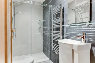a bathroom with a shower and a toilet and a sink at Dream Apartments Prague in Prague