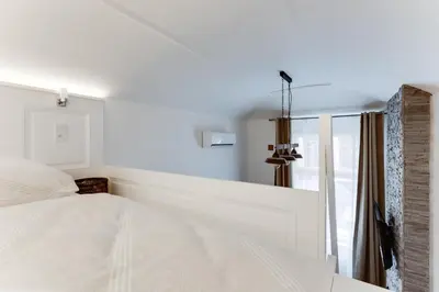a bedroom with a white bed and a window at Dream Apartments Prague in Prague