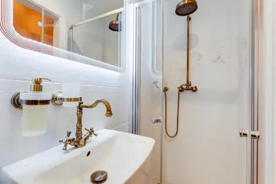 a bathroom with a sink and a shower at Dream Apartments Prague in Prague