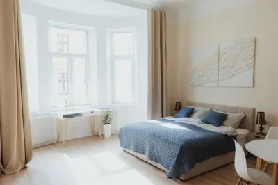 a bedroom with a bed and a table in it at 7th Heaven Apartment close to metro and center in Prague