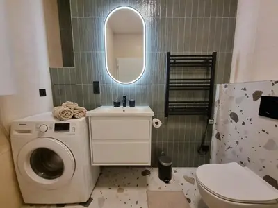 a hallway with a mirror and a door at 7th Heaven Apartment close to metro and center in Prague