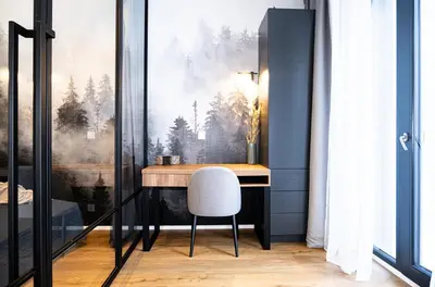 a living room with a couch and a table at Rentero Scandinavian - Private Garden APT in Prague