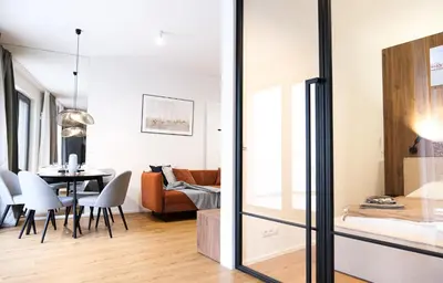 a living room with a couch and a flat screen tv at Rentero Scandinavian - Private Garden APT in Prague