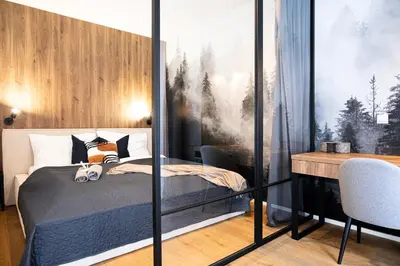 a living room with a couch and a table at Rentero Scandinavian - Private Garden APT in Prague