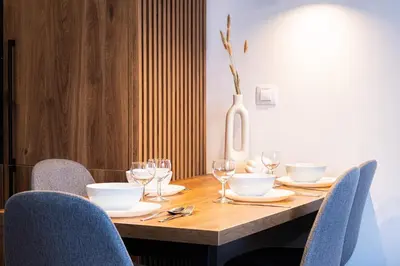 a dining room table with chairs and a vase at Rentero Michelska Residence Scandinavian Quiet Apartment, Prague in Prague