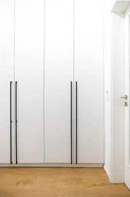 a row of white closet doors in a room at Rentero Michelska Residence Scandinavian Quiet Apartment, Prague in Prague