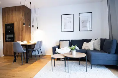 a living room with a blue couch and a table at Rentero Michelska Residence Scandinavian Quiet Apartment, Prague in Prague