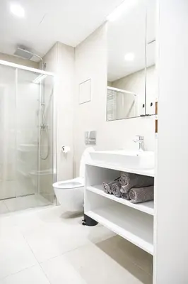 a white bathroom with a sink and a toilet at Rentero Michelska Residence Scandinavian Quiet Apartment, Prague in Prague