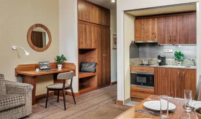 a kitchen and dining room with a table and chairs at Crown Palace Apartments by Adrez in Prague
