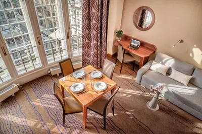 a living room with a table and a couch at Crown Palace Apartments by Adrez in Prague