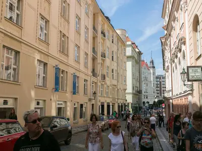 a group of people walking down a street with buildings at Old Town Residence by Little King in Prague