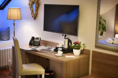a room with a desk with a television and a telephone at Old Town Residence by Little King in Prague