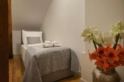 a bedroom with a bed and a vase of flowers at Old Town Residence by Little King in Prague