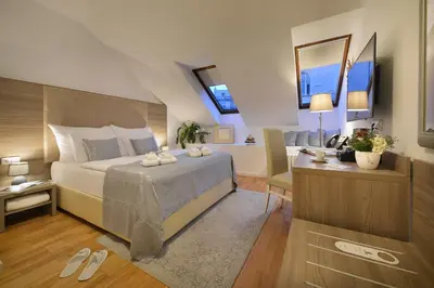 a bedroom with a bed and a desk and a room at Old Town Residence by Little King in Prague