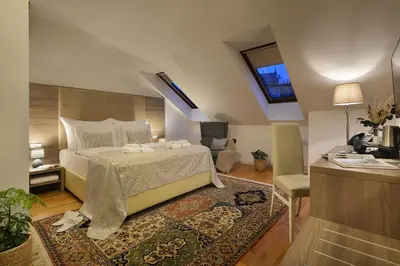 a bedroom with a bed and a desk and a window at Old Town Residence by Little King in Prague
