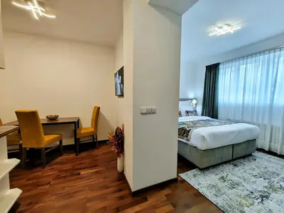 a bedroom with a bed and a desk and a table at Old Town Residence by Little King in Prague