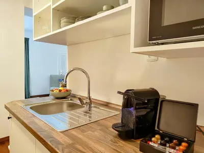 a kitchen counter with a sink and a microwave at Old Town Residence by Little King in Prague