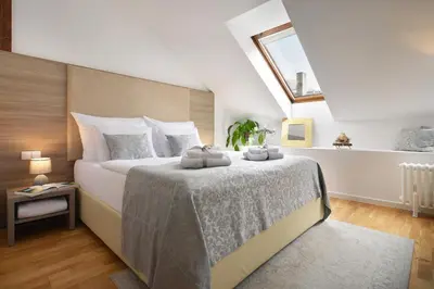 a bedroom with a bed with two towels on it at Old Town Residence by Little King in Prague